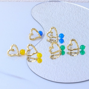 Detail of 18K gold-plated heart earrings with colorful green and blue agate beads