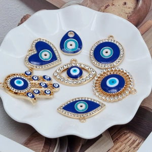 Variety of Evil Eye charms in heart and Hamsa shapes for DIY jewelry making