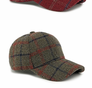 Detail of wool plaid baseball cap in olive green with red and blue checkered pattern