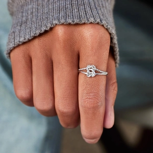 Minimalist S925 sterling silver double heart knot open ring set on grey sweater texture