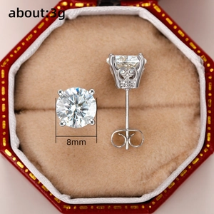 Macro shot of silver crown earrings with cubic zirconia in a red jewelry box
