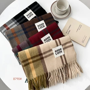 Detail showing various plaid patterns and fringe of thick cashmere-like warm scarves