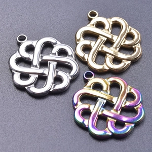 Macro detail of Celtic knot heart charms in silver, gold, and iridescent steel finishes