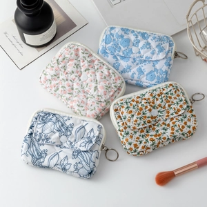 Detailed set of four quilted floral cotton storage pouches with zip and button pockets