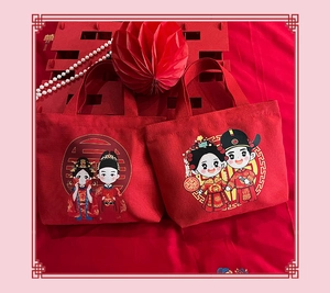 Detail of red wedding canvas gift bags with cartoon bride and groom illustrations