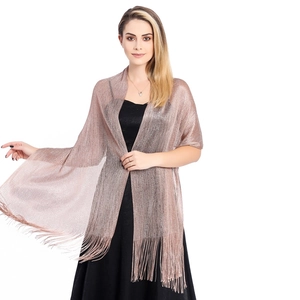 Detail of rose gold metallic shawl with shimmering tassels for wedding evening wear