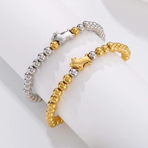 Minimalist elastic pig charm bracelet with gold and silver steel beads on white display