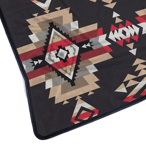 Detail view of the thick flannel blanket edge with bohemian geometric tribal patterns
