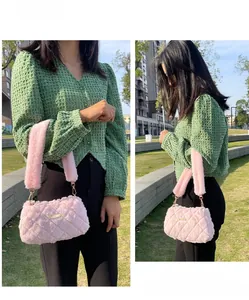 Pink plush shoulder bag with quilted fur texture and gold metal logo plaque details