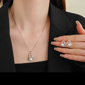 Elegant silver gourd jewelry set with zircon and pearls on a professional model
