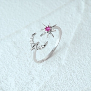 Detailed macro view of S925 silver star and moon open ring with pink zircon gemstone