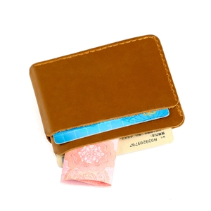 Detail of brown crazy horse leather card holder with manual stitching and double slots