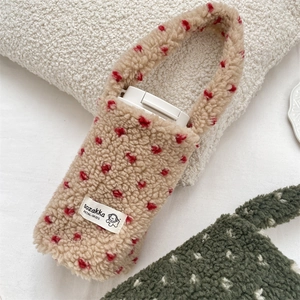 Detail of plush heart-patterned cup carrier bag with soft texture and sturdy handle