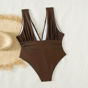 Detail of dark brown V-neck one-piece swimsuit featuring elegant ruched waist and texture
