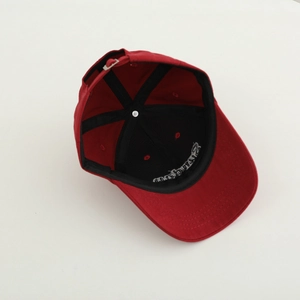 Interior view of red cotton baseball cap featuring sweatband and adjustable metal buckle