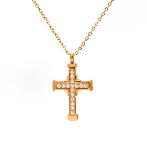 Close-up of 18K gold plated cross pendant with sparkling crystals on white background