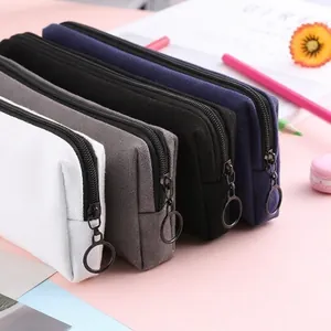 Minimalist canvas pencil cases in four colors with stylish large circular metal zippers