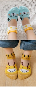 Close-up of breathable mesh socks for kids featuring bear and giraffe cartoon patterns