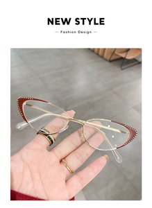 Detailed view of cat-eye gold metal frames with red glitter and sparkling rhinestones