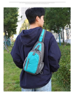 Outdoor model shot of gray and teal waterproof crossbody chest bag for men