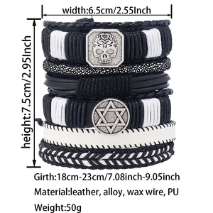 Close-up of black braided leather bracelets set with skull and star charms detailing