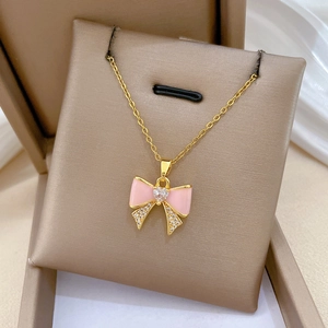 Elegant gold titanium steel necklace with pink bow pendant and heart-shaped crystal