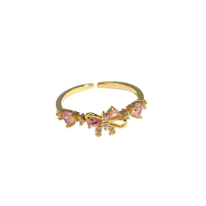 Adjustable gold bow ring with pink heart gemstones and sparkling cubic zirconia