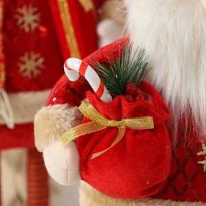 Standing Santa reindeer doll with red velvet gift bag and festive gold ribbon details