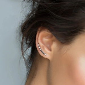 Minimalist silver geometric ear crawler earring on model in a modern style