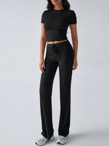 Detailed view of women's black short sleeve top and loose straight pants casual two-piece set