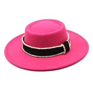 Detailed close-up of hot pink wool felt boater hat with beaded black ribbon band trim