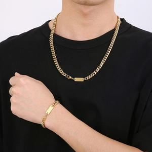 Men's gold Cuban link chain necklace and bracelet set with rectangle plate pendant on model