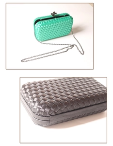 Detailed view of woven texture and chain strap on green and black evening clutch bags