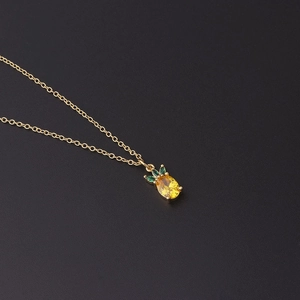 Minimalist gold necklace featuring a yellow and green zircon pineapple pendant charm
