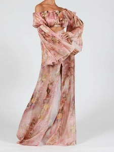 Detail of pink floral two-piece set with off-shoulder crop top and high slit chiffon skirt