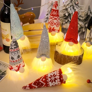 Macro detail of LED glowing Christmas gnomes with knitted hats and faux fur beards