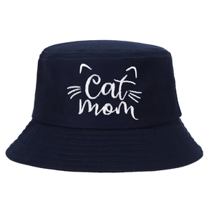 Detail showing Cat Mom embroidery and white line art on a navy blue cotton bucket hat