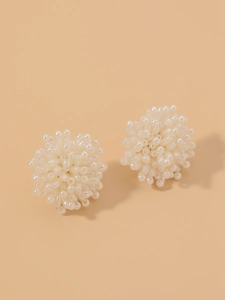 Close-up of handmade faux pearl flower cluster earrings with elegant beaded texture
