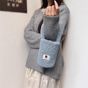 Light blue plush handbag with a cartoon black cat patch and soft faux fur texture