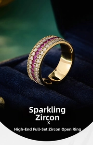 Close-up of gold-plated compass ring with micro-pave red and white zircons