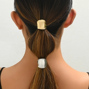 French vintage metallic ponytail hair clips in gold and silver finish on model