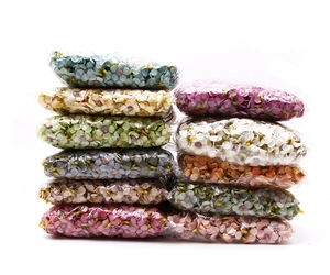 Close-up of colorful 2cm mini silk daisy heads packed in transparent poly bags for DIY