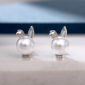 Elegant rabbit ear pearl stud earrings in silver finish for a minimalist fashion look