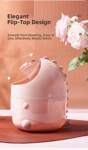 Pink dinosaur mini desktop trash can with flip lid and cute decorative fins detail