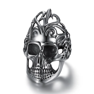 Detailed macro view of vintage stainless steel skull ring with intricate vine engravings