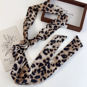 Detail of French vintage leopard print silk scarf necklace with elegant pearl beads
