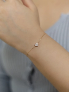 Elegant 14K gold plated S925 silver heart bracelet with cubic zirconia on a female wrist