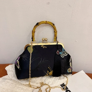 Elegant black embroidered handbag with bamboo handle and gold chain strap in Chinese style