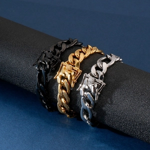 Three Cuban link bracelets in black, gold and silver on a cylinder display stand