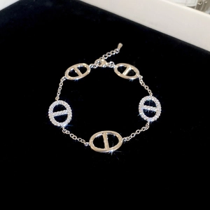 Detail of silver chain bracelet with zircon pavé pig nose links on black velvet
